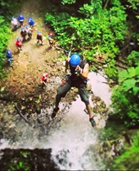 Rivera rappelling off a waterfall in Costa Rica